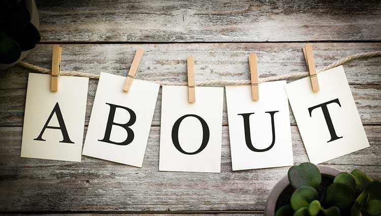 About Us sign on rustic wooden background