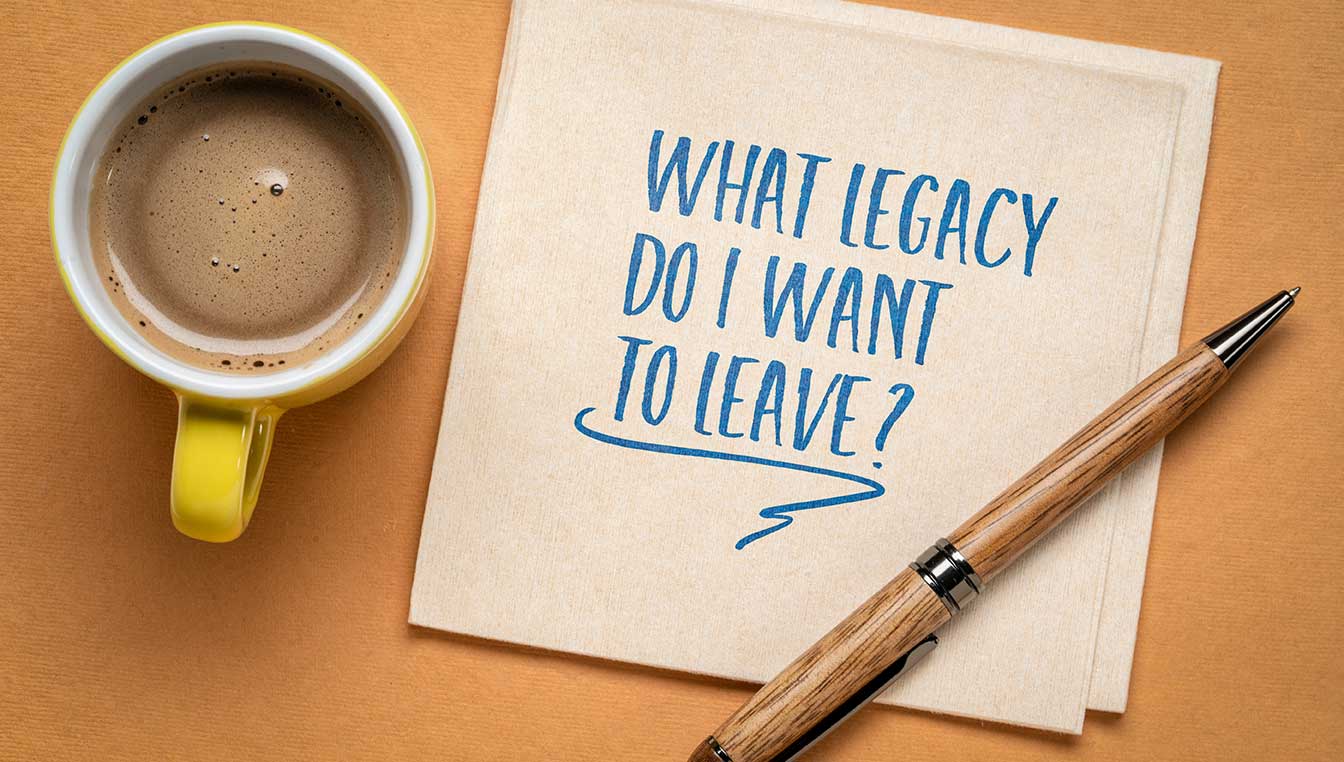 Coffee mug with note pad reading what legacy do I want to leave?
