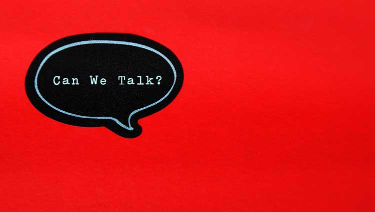 "Can we talk?" word bubble in a red background