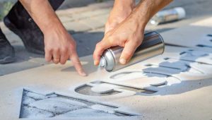 An image of a man using a stencil to paint similar to using a will template.